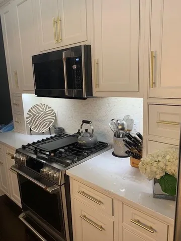 a kitchen with a stove and a microwave