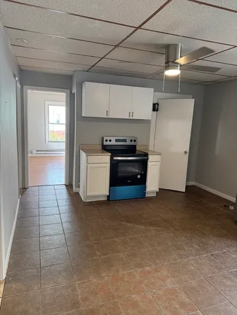 a view of kitchen with refrigerator and stove