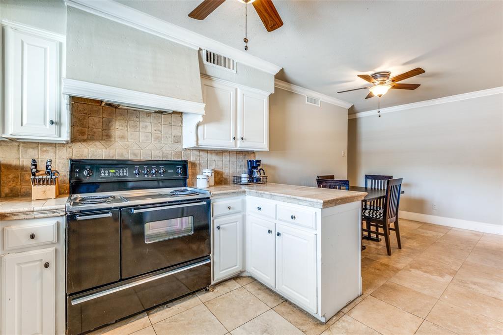 6353 Diamond Head Circle, Unit D Dallas, TX 75225 - Photo 12 of 25 a kitchen with appliances cabinets and a sink