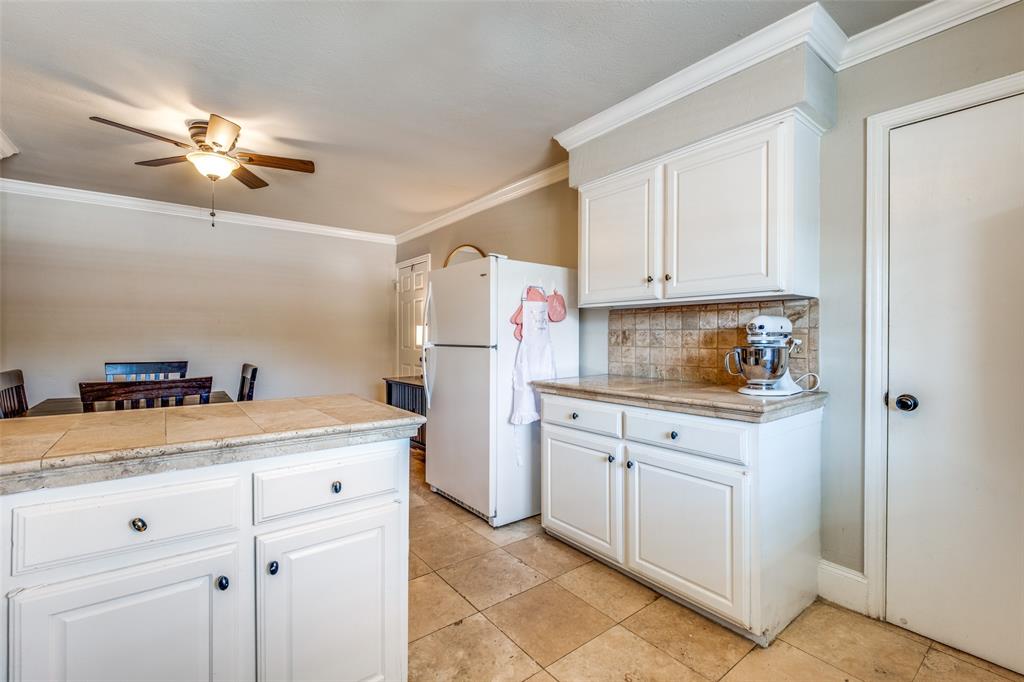 6353 Diamond Head Circle, Unit D Dallas, TX 75225 - Photo 14 of 25 a kitchen with a sink dishwasher and white cabinets with wooden floor