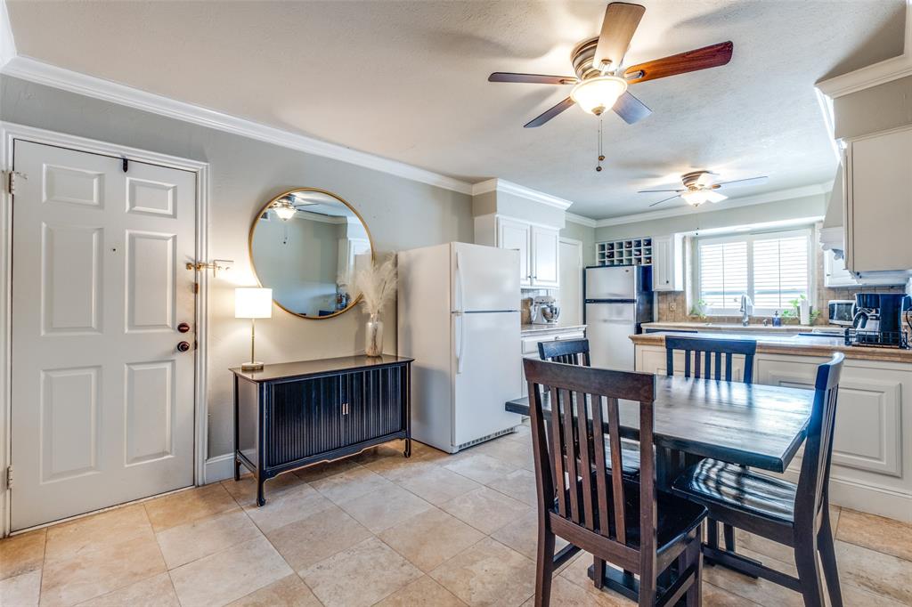 6353 Diamond Head Circle, Unit D Dallas, TX 75225 - Photo 15 of 25 a view of a dining room with furniture and a wooden floor