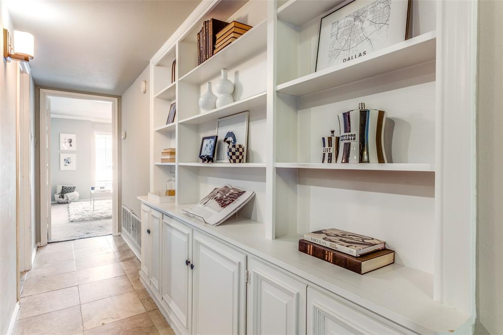 6353 Diamond Head Circle, Unit D Dallas, TX 75225 - Photo 17 of 25 a hallway with a book shelf