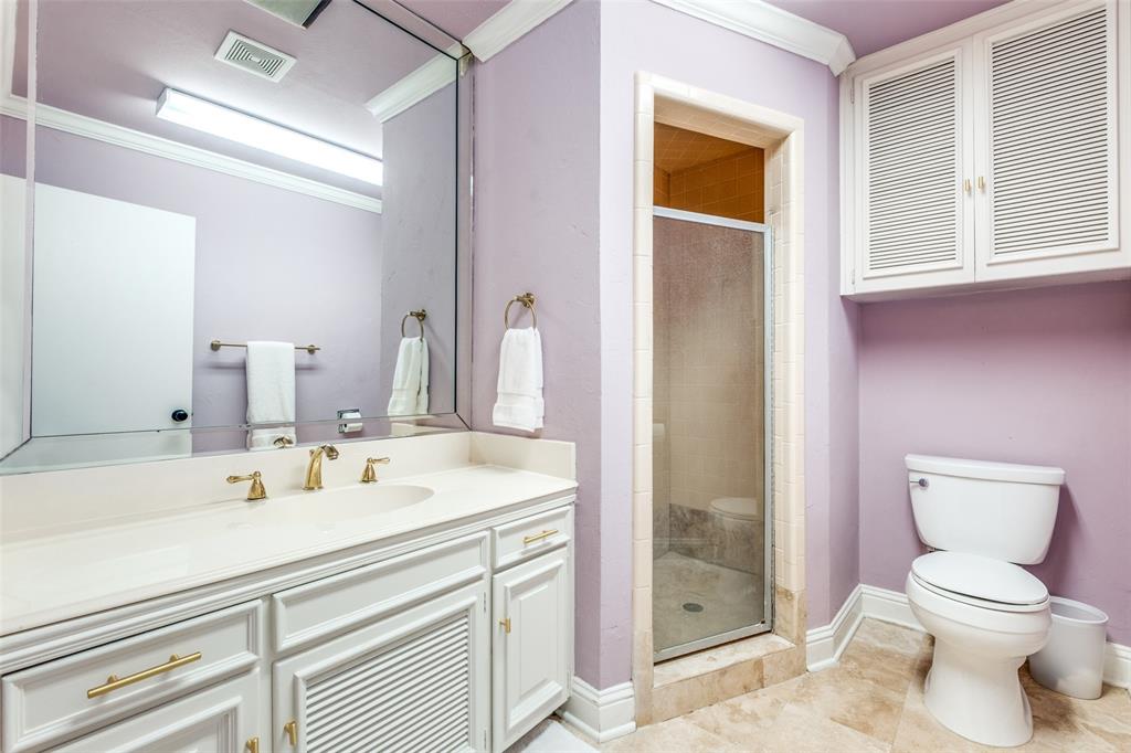 6353 Diamond Head Circle, Unit D Dallas, TX 75225 - Photo 23 of 25 a bathroom with a sink a toilet and shower