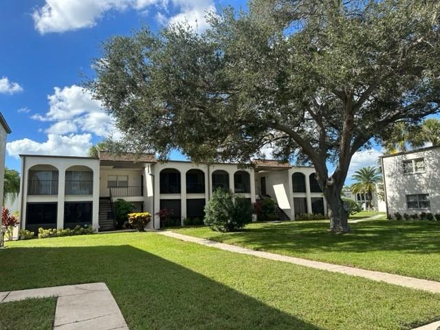 7701 Starkey Road, Unit 731 Seminole, FL 33777 - Photo 2 of 19 front view of a house with a yard