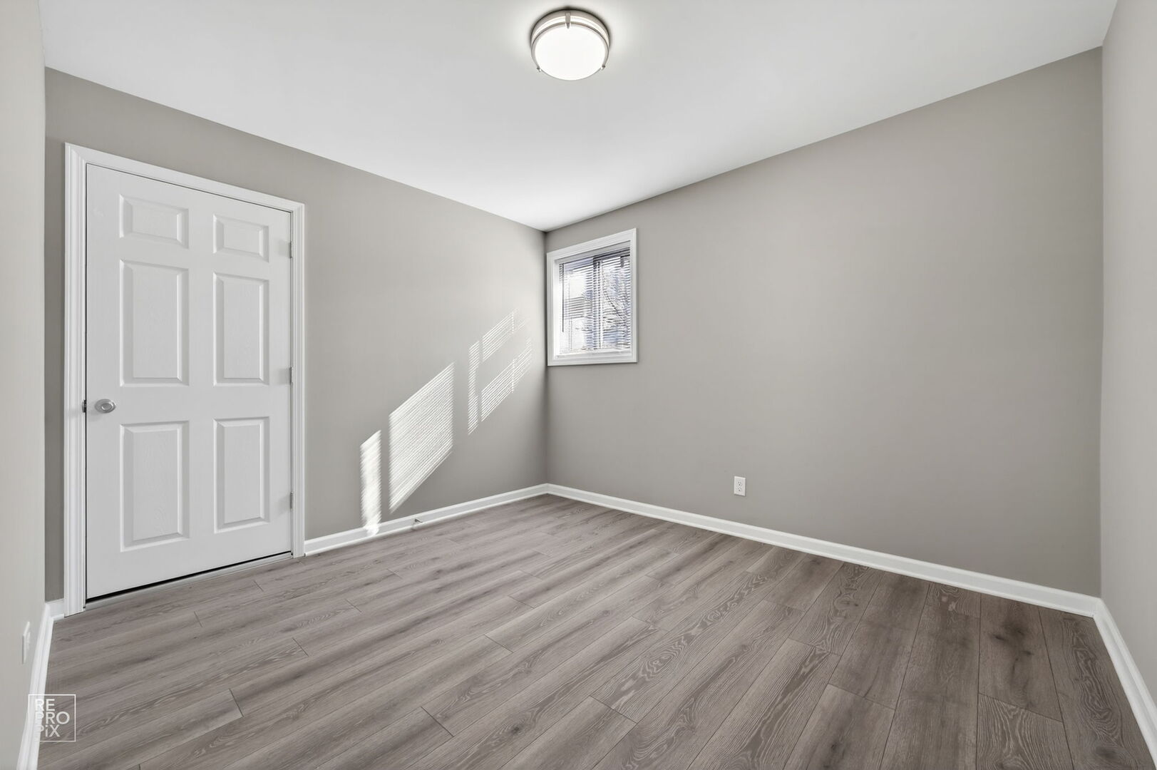 4680 West 83rd Street Chicago, IL 60652 - Photo 12 of 22 a view of an empty room with wooden floor and a window