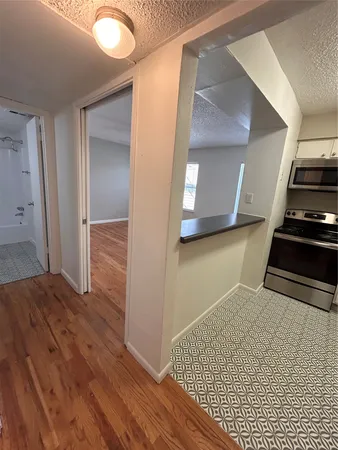 a view of a hallway with wooden floor