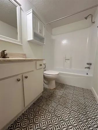 a bathroom with a toilet a sink and a window