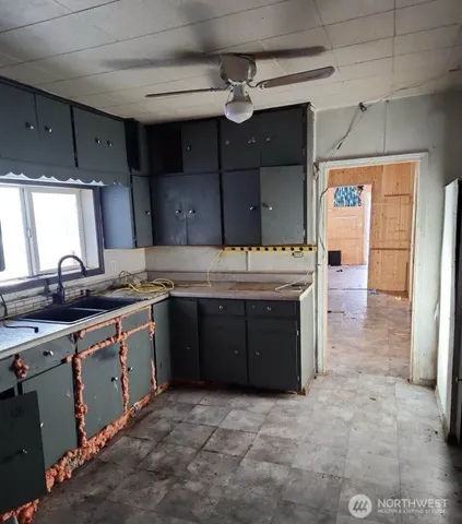 a kitchen with a sink stove and cabinets