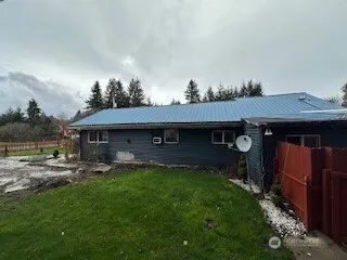a backyard of a house with table and chairs