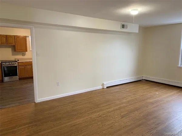 a view of a room with wooden floor and a sink