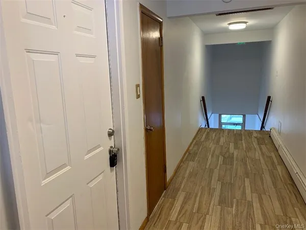a view of a hallway with wooden floor and a hallway