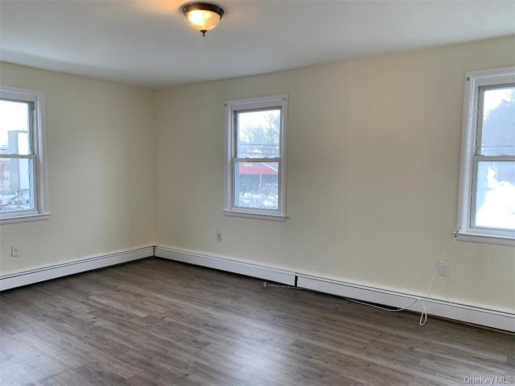 5273 Rte 9W, Unit NORTH Newburgh, NY 12550 - Photo 2 of 21 an empty room with wooden floor and windows