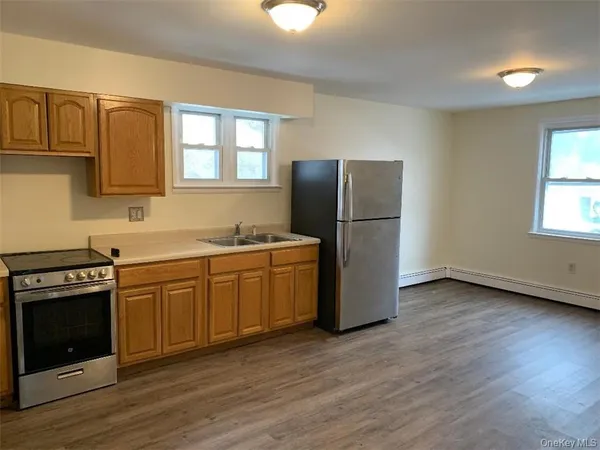 a kitchen with a refrigerator sink and cabinets