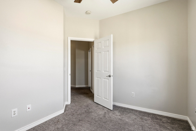 1177 Northfield Road, Unit 26 Cedar City, UT 84721 - Photo 27 of 45 Interior room featuring neutral wall paint, gray patterned carpeting, white baseboards, and a white paneled door with silver hardware