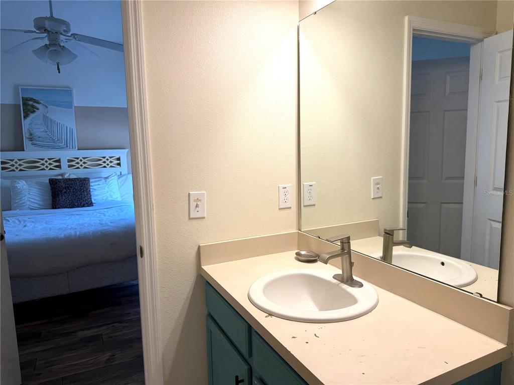 4573 Ada Lane Kissimmee, FL 34746 - Photo 11 of 37 a bathroom with a sink and a mirror