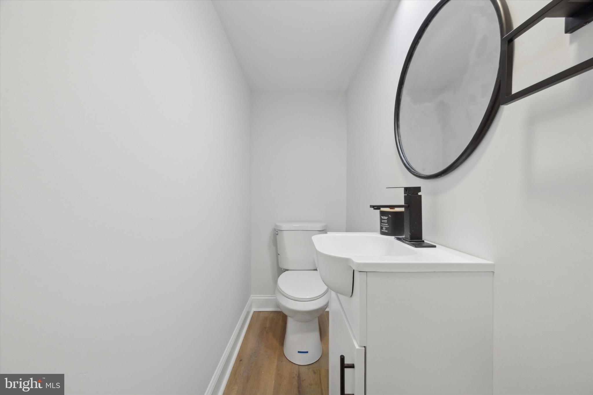 2124 Arleigh Road Cinnaminson, NJ 08077 - Photo 17 of 31 a bathroom with a toilet a sink and a mirror