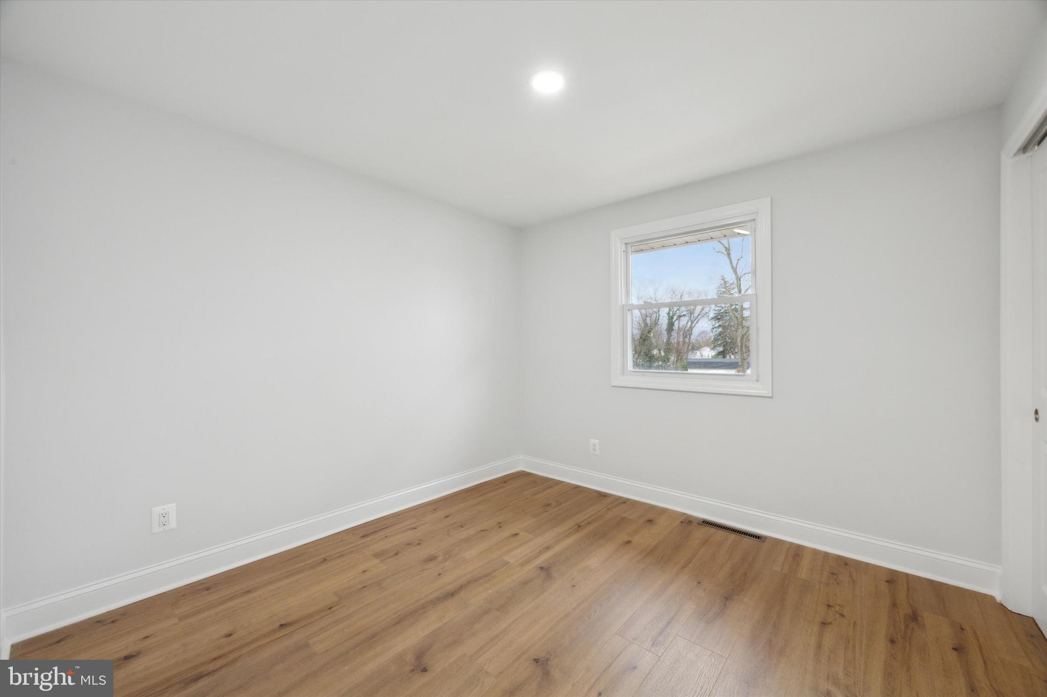2124 Arleigh Road Cinnaminson, NJ 08077 - Photo 21 of 31 an empty room with wooden floor and windows