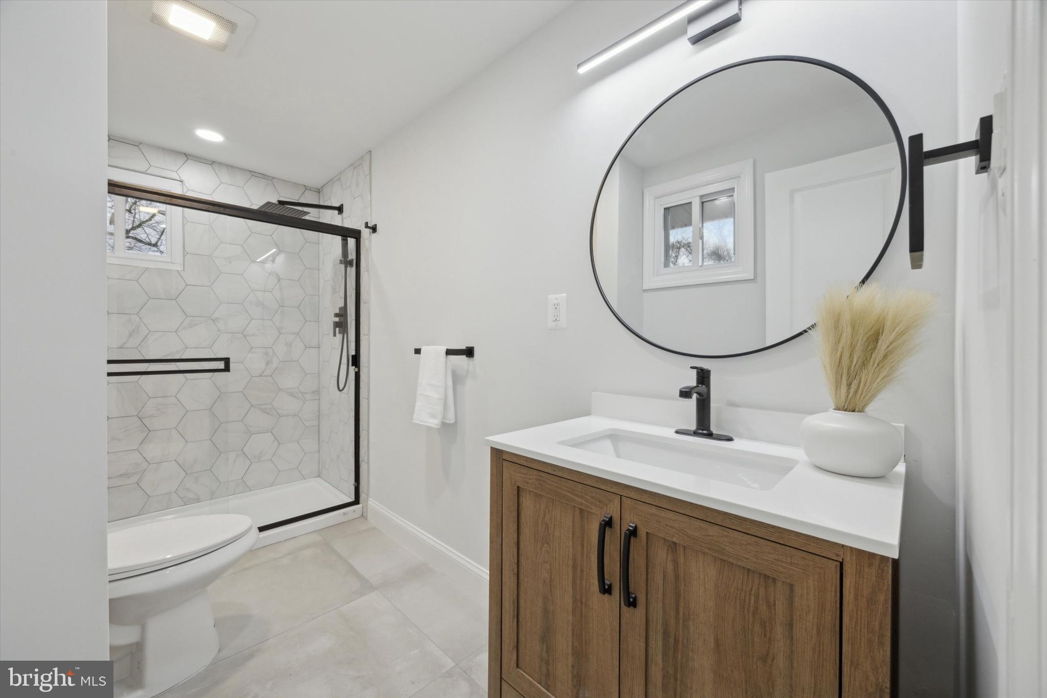 2124 Arleigh Road Cinnaminson, NJ 08077 - Photo 24 of 31 a bathroom with a sink a mirror a vanity and shower