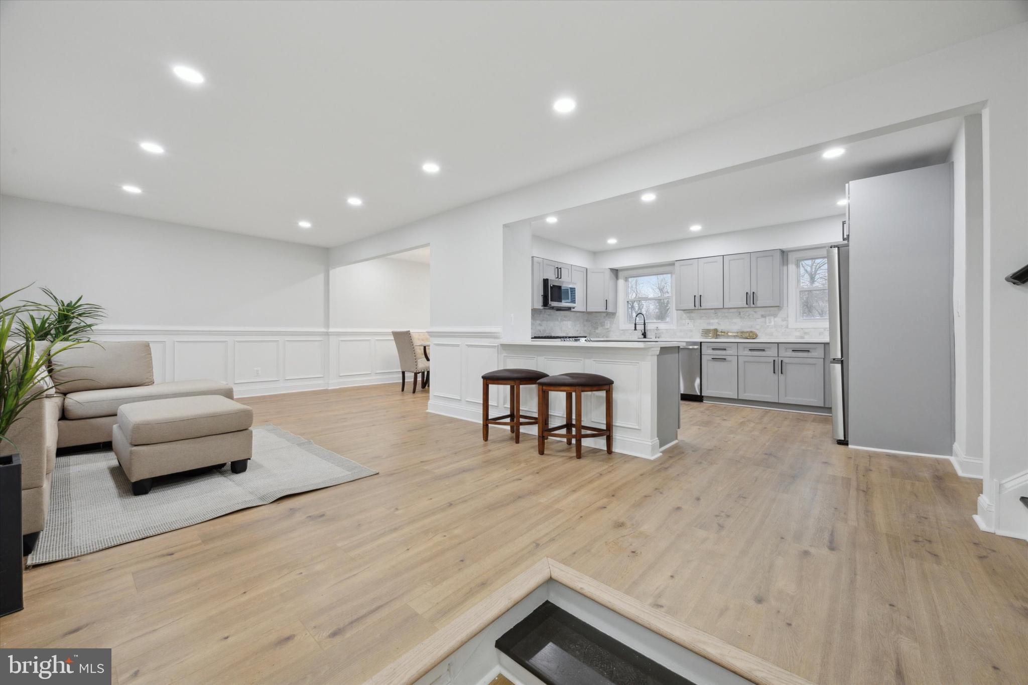 2124 Arleigh Road Cinnaminson, NJ 08077 - Photo 6 of 31 a living room with stainless steel appliances furniture wooden floor and a kitchen view