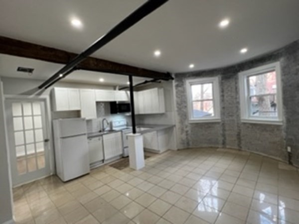 147 Winthrop Road, Unit 2 Brookline, MA 02445 - Photo 13 of 19 a view of a big room with chandelier and windows