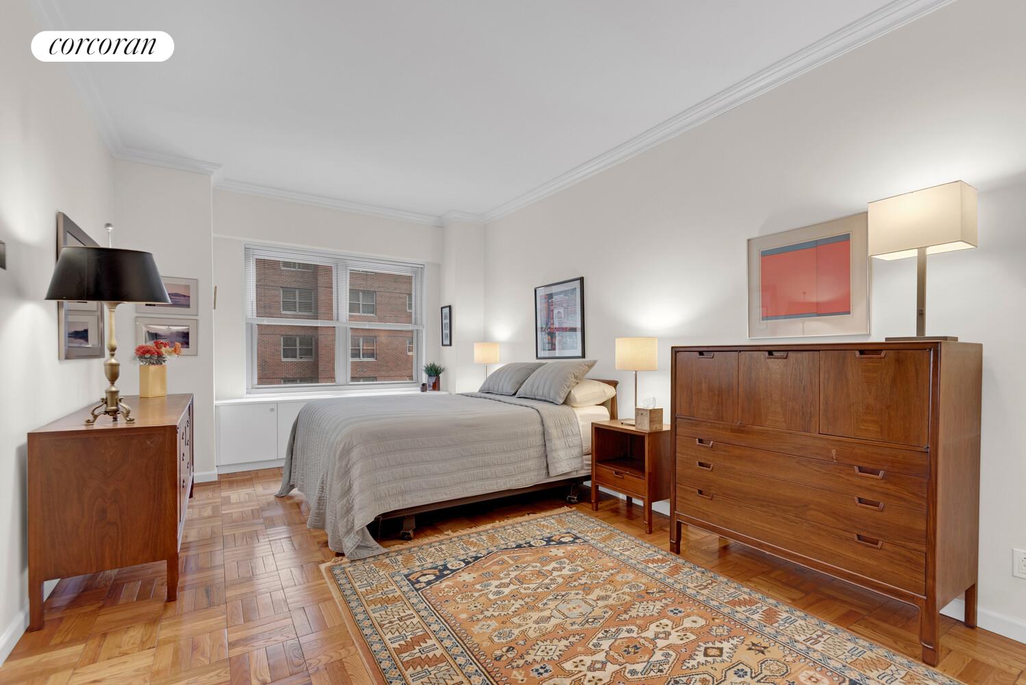 360 East 72nd Street, Unit B811 Manhattan, NY 10021 - Photo 4 of 15 a bedroom with a bed and wooden floor