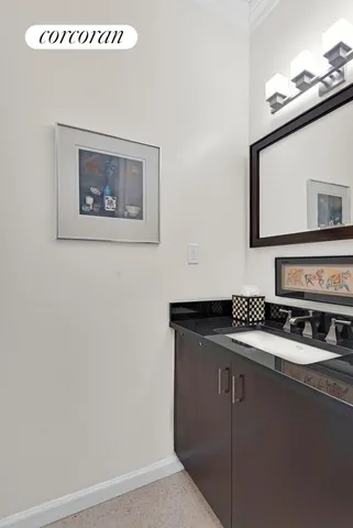 a bathroom with a sink mirror vanity and toilet