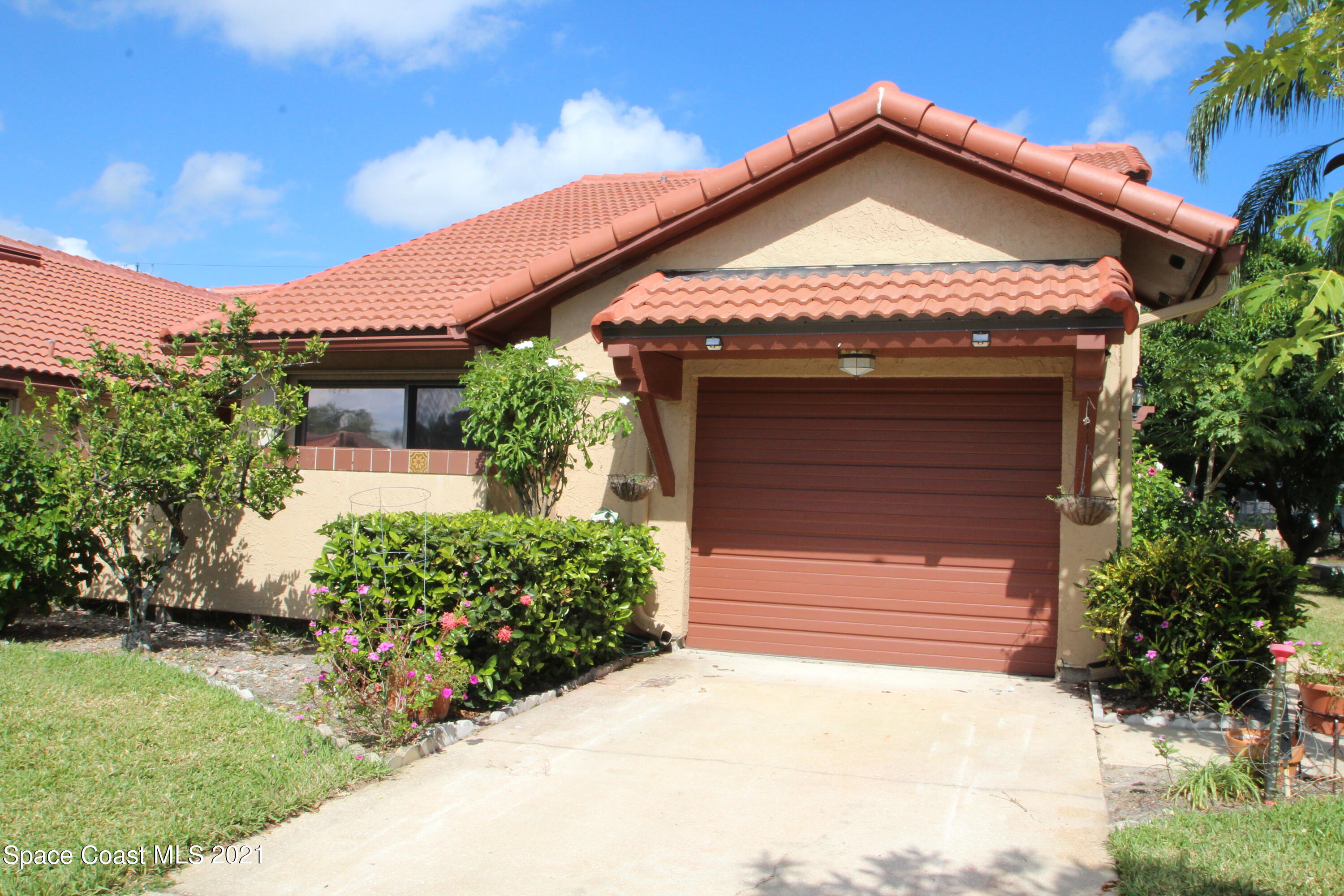 1691 Avery Road Northeast Palm Bay, FL 32905 - Photo 1 of 20 a front view of a house with a garden