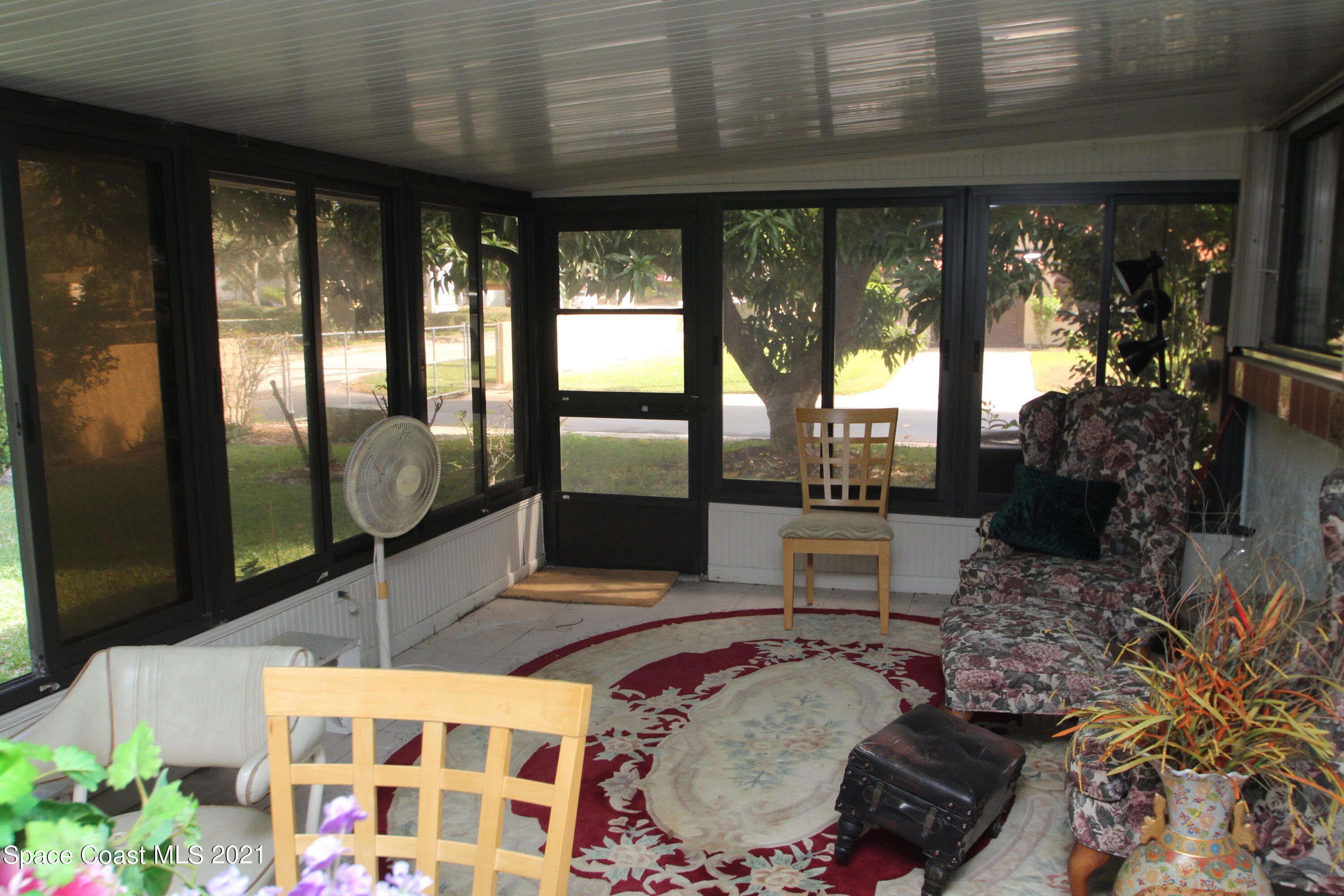 1691 Avery Road Northeast Palm Bay, FL 32905 - Photo 14 of 20 a living room filled with furniture and a floor to ceiling window