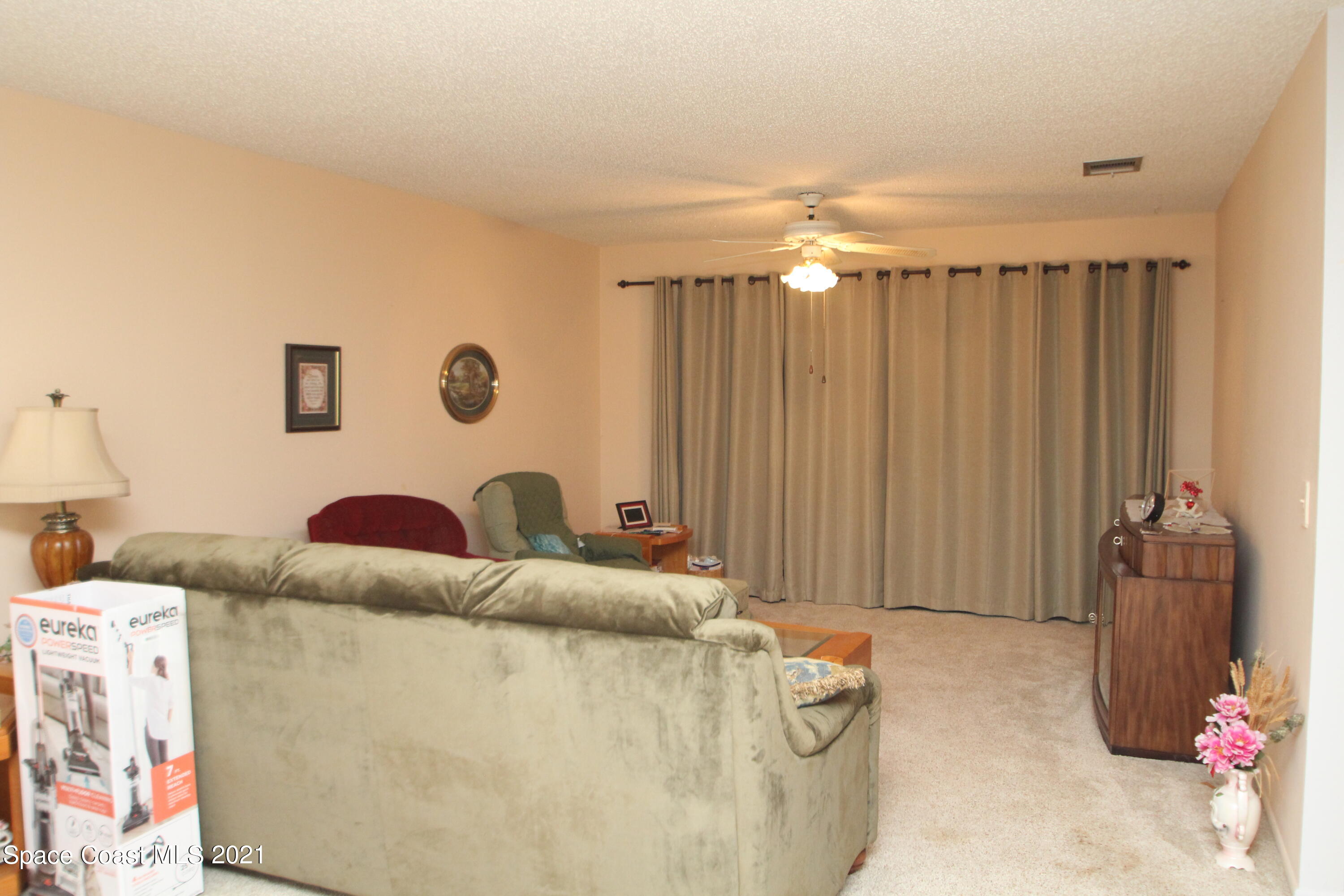 1691 Avery Road Northeast Palm Bay, FL 32905 - Photo 7 of 20 a living room with furniture and a chandelier