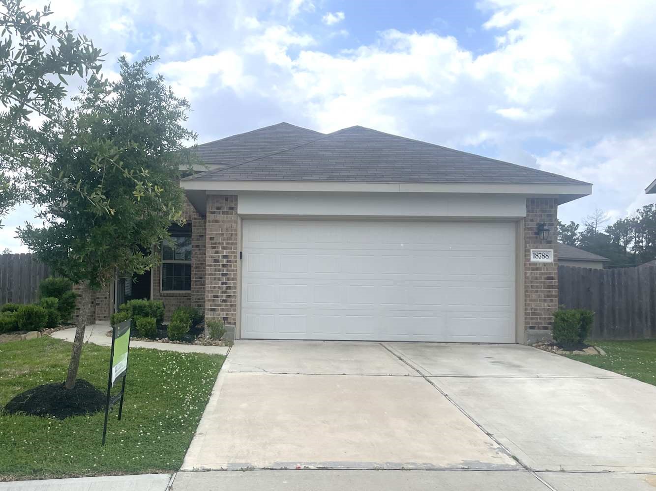 18788 Faustina Way New Caney, TX 77357 - Photo 1 of 9 a front view of a house with a yard and garage