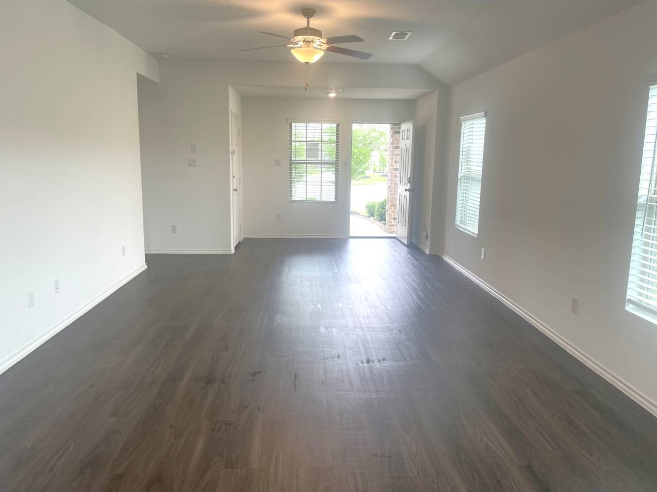 18788 Faustina Way New Caney, TX 77357 - Photo 2 of 9 an empty room with wooden floor and windows