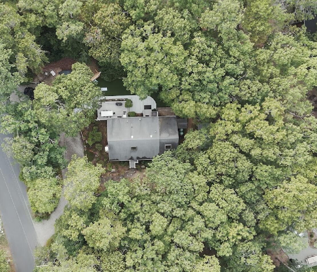 an aerial view of a house with a yard