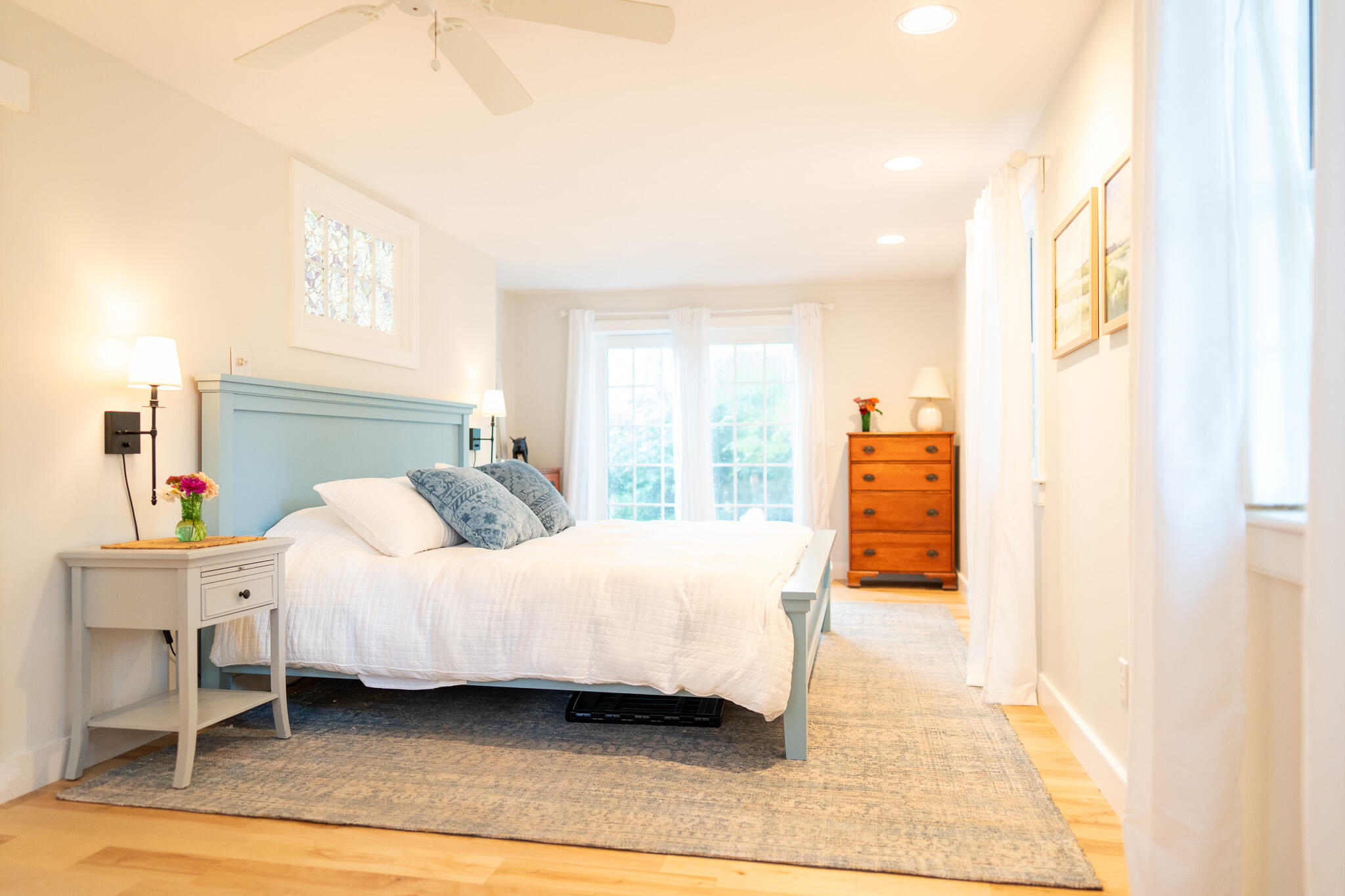 230 Massasoit Trail Eastham, MA 02642 - Photo 22 of 64 a bedroom with a bed lamp and a large window