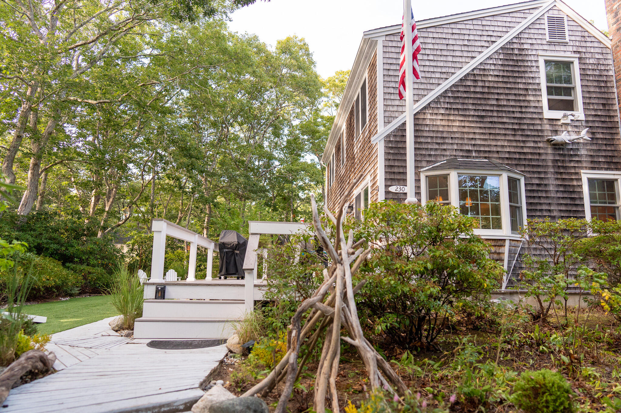 230 Massasoit Trail Eastham, MA 02642 - Photo 5 of 64 a front view of a house with a yard