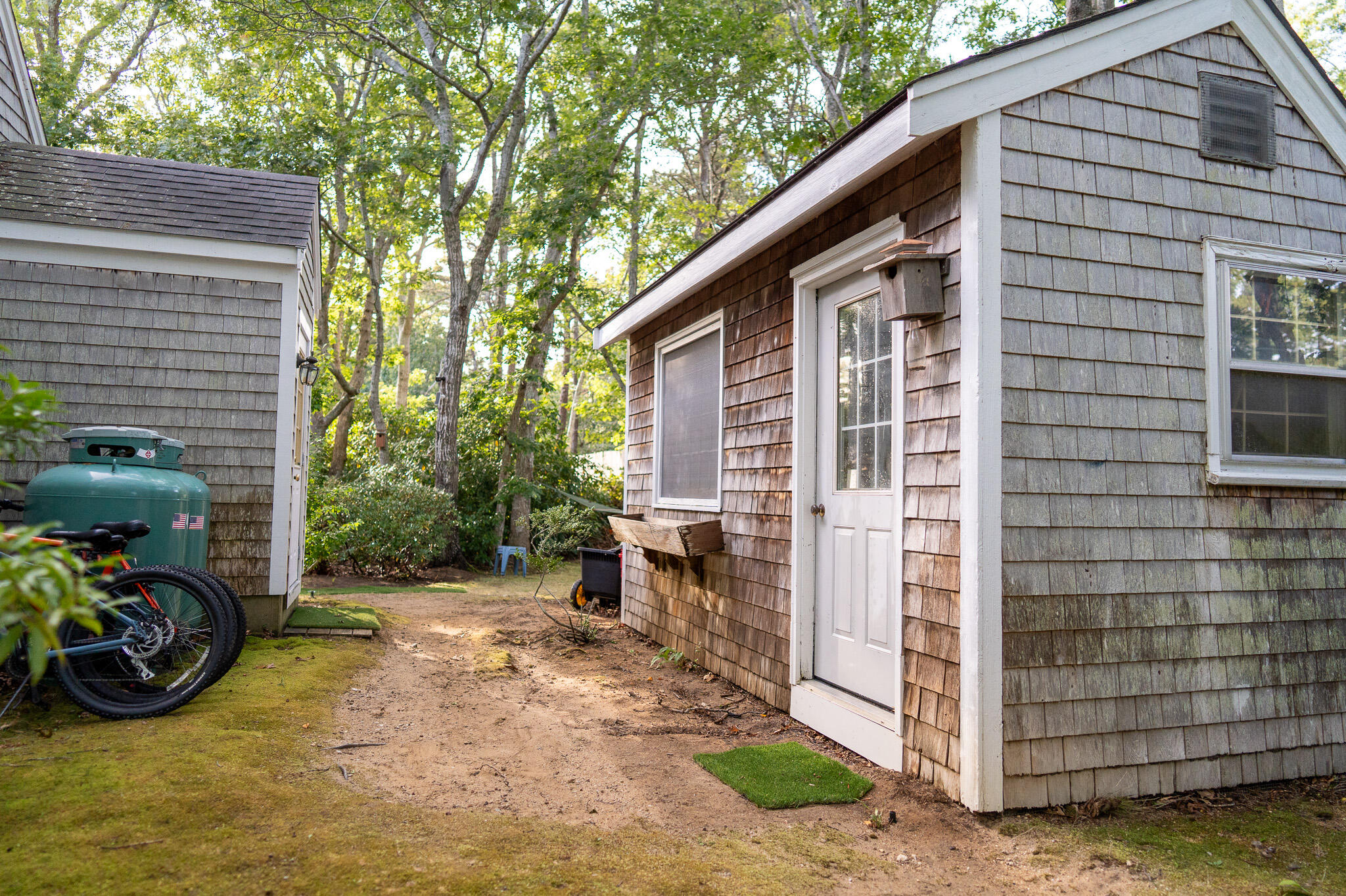 230 Massasoit Trail Eastham, MA 02642 - Photo 52 of 64 a view of a chair and tables in the house and front view of the house