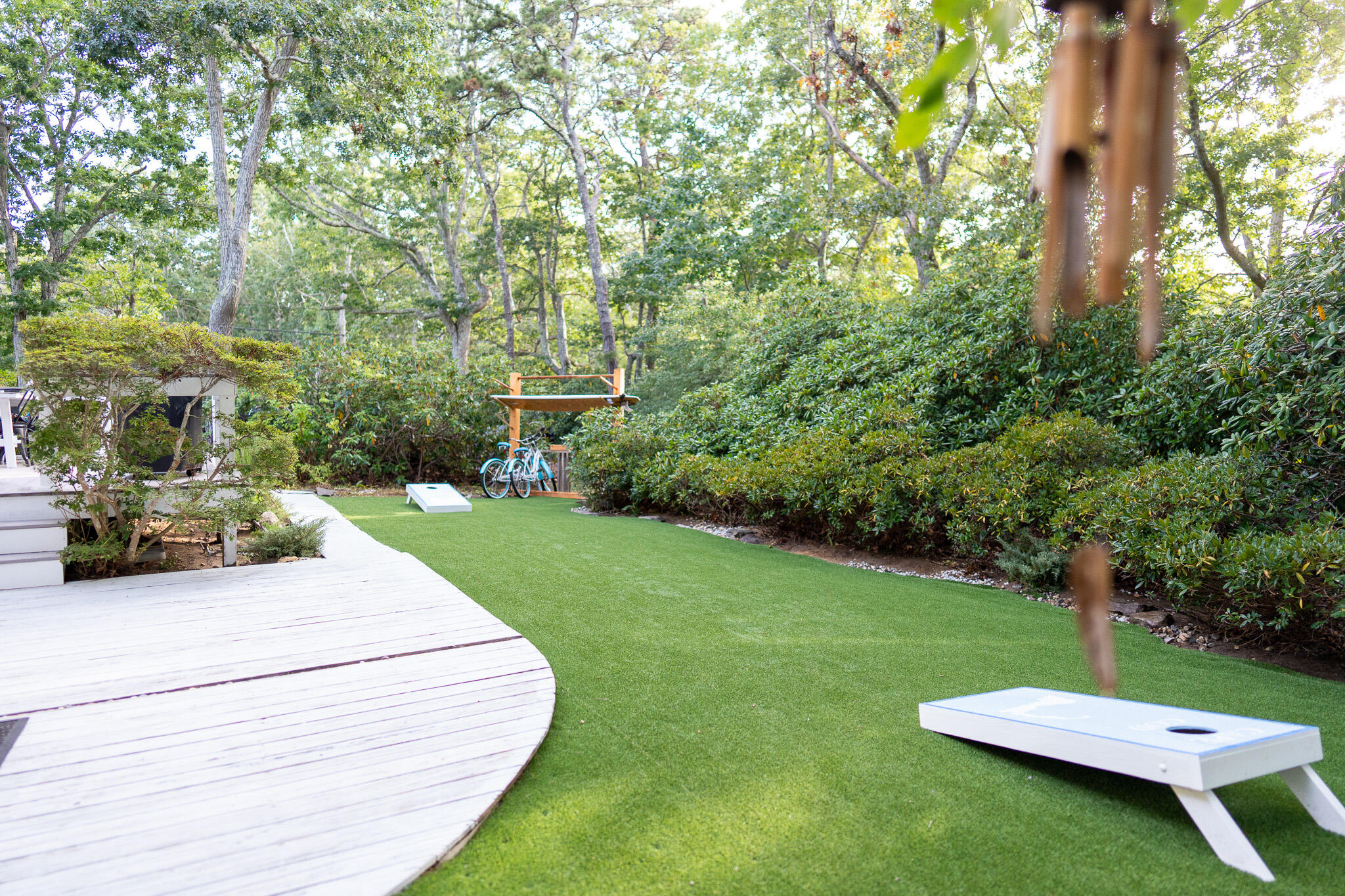 230 Massasoit Trail Eastham, MA 02642 - Photo 8 of 64 a view of a backyard with table and chairs plants and trees