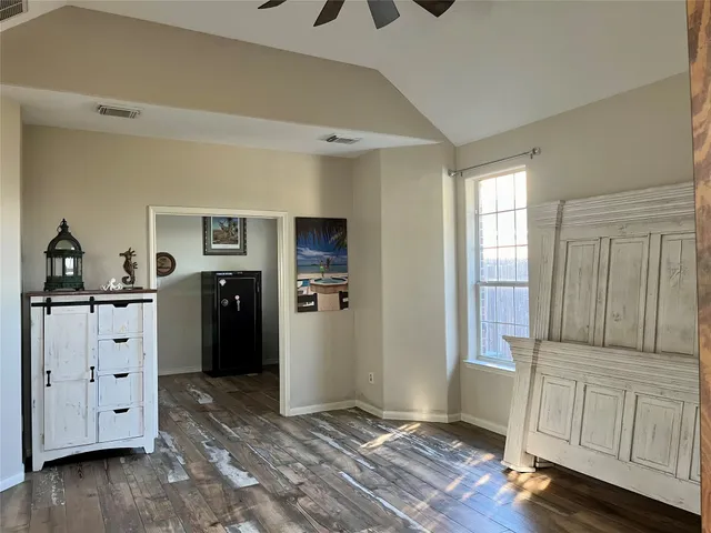 a kitchen with granite countertop stainless steel appliances and wooden floor