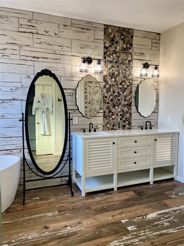 a bathroom with a mirror and a sink