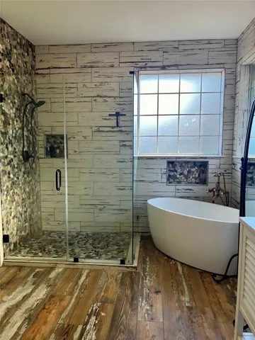 a bathroom with a bathtub and shower