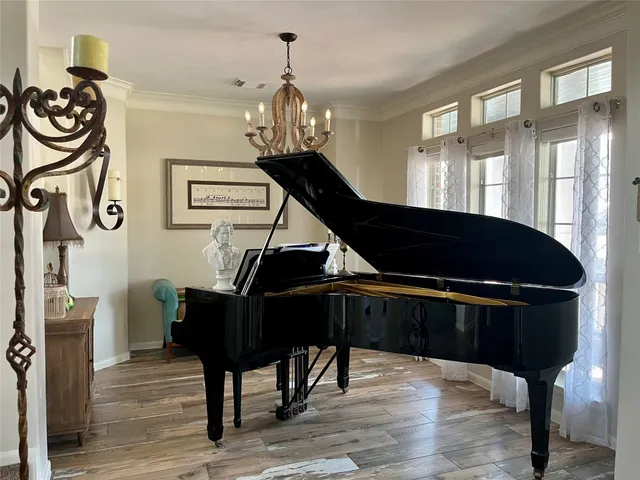 a view of a dining room with furniture and chandelier