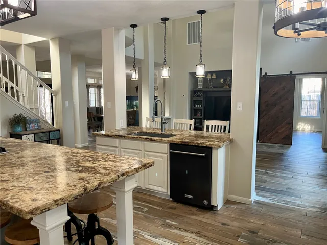 a kitchen with stainless steel appliances granite countertop a stove and cabinets