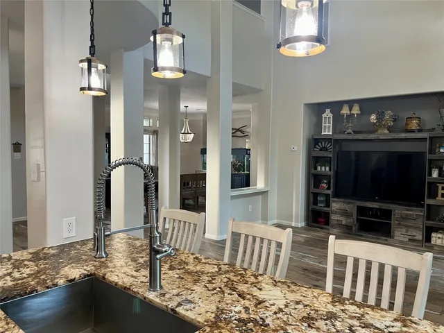 a kitchen with stainless steel appliances granite countertop a stove refrigerator and cabinets