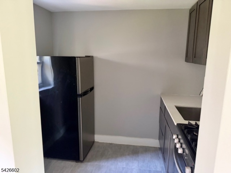 10 Beech Spring Drive, Unit 7C Summit, NJ 07901 - Photo 3 of 6 a view of room with cabinets and refrigerator