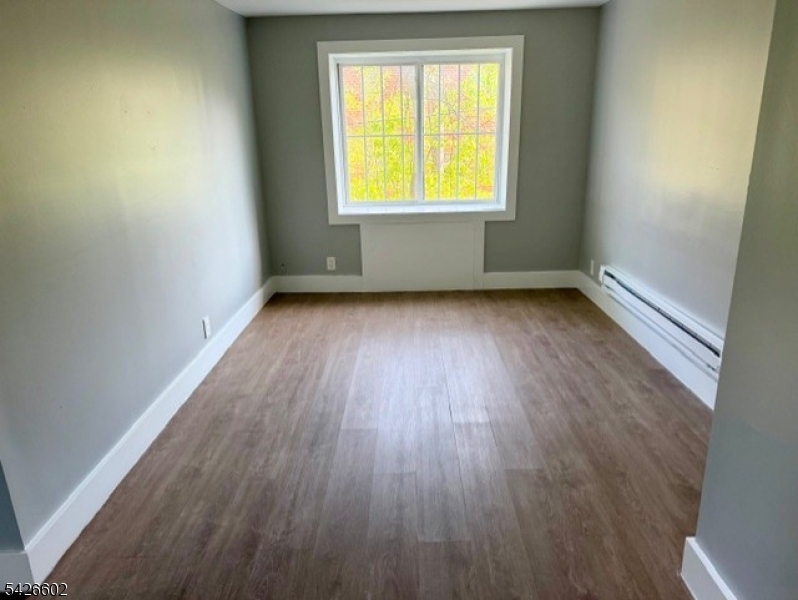 10 Beech Spring Drive, Unit 7C Summit, NJ 07901 - Photo 5 of 6 an empty room with wooden floor and a window
