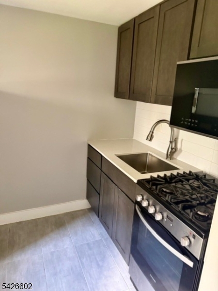 10 Beech Spring Drive, Unit 7C Summit, NJ 07901 - Photo 6 of 6 a kitchen with a stove and a cabinet