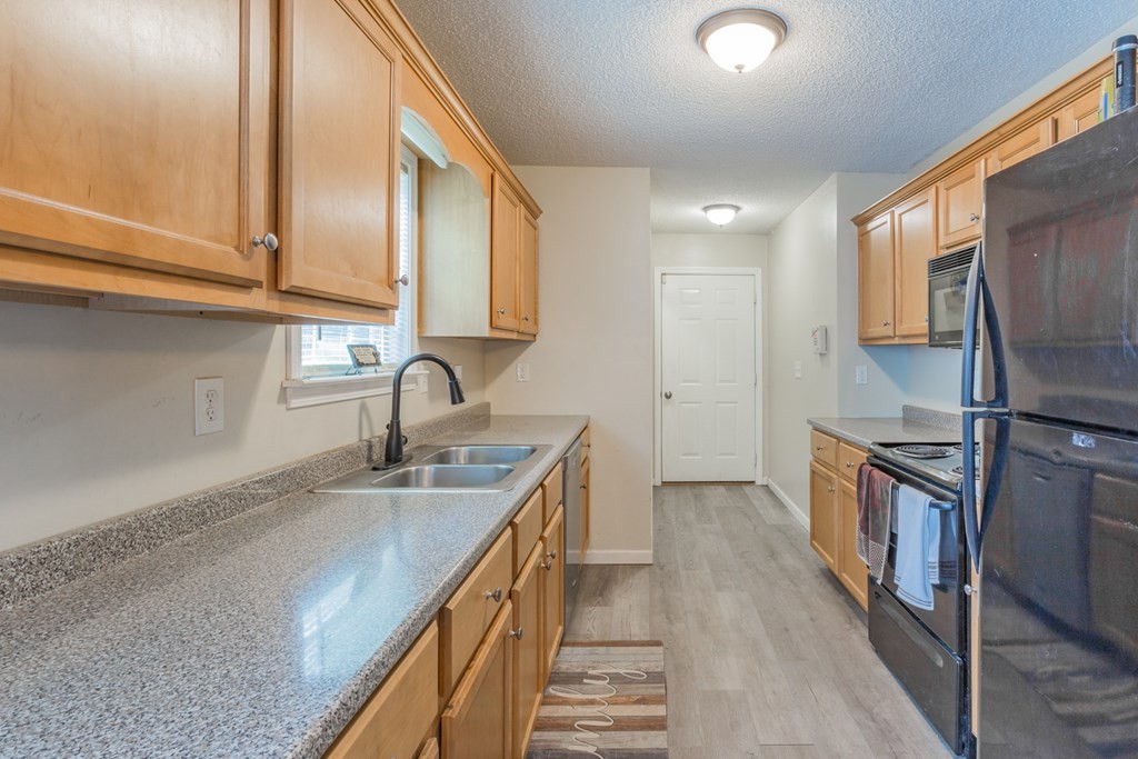 2322 Waring Road Northwest Dalton, GA 30721 - Photo 11 of 21 a kitchen with granite countertop a sink a counter top space stainless steel appliances and cabinets