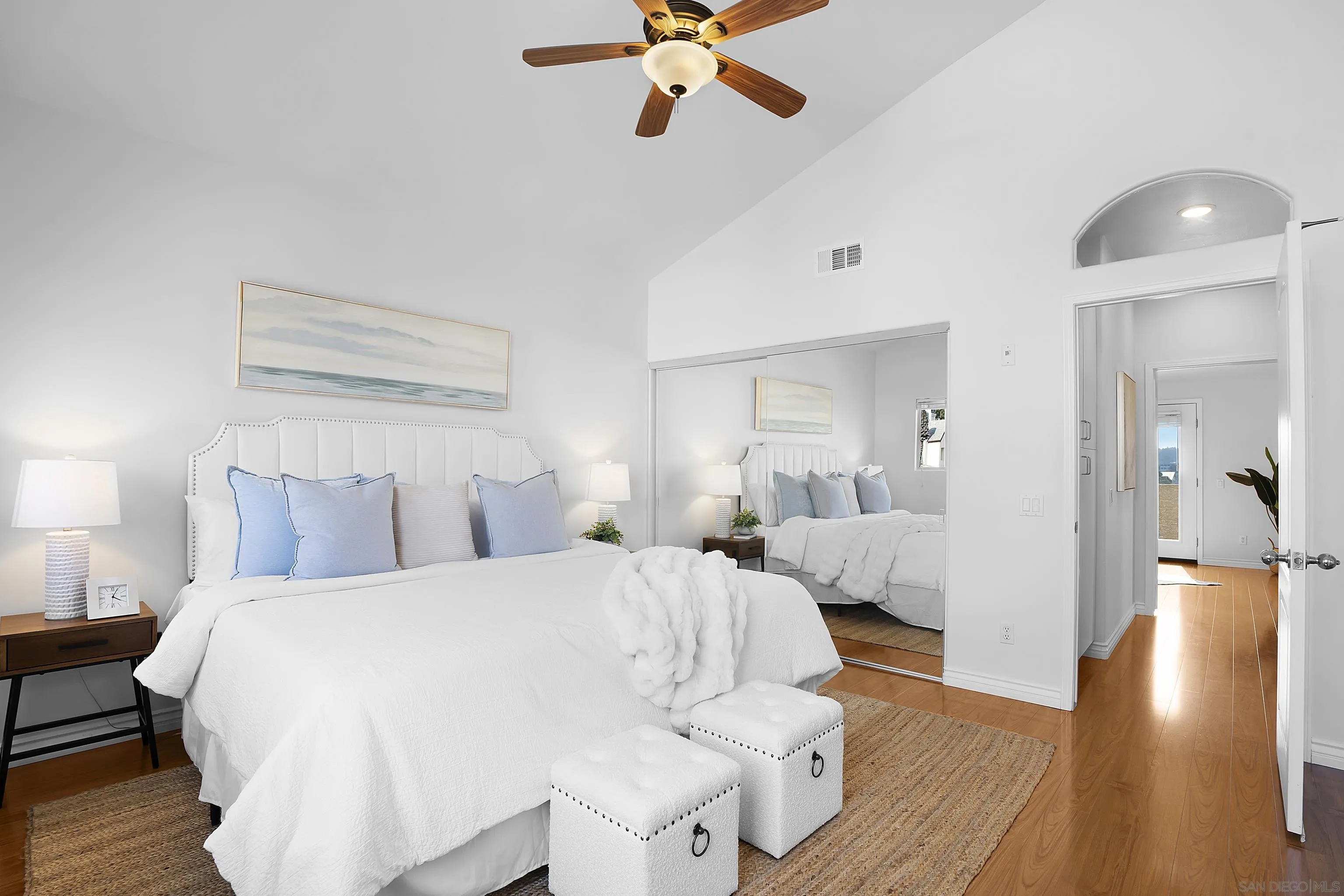 12646 Carmel Country Road, Unit 159 San Diego, CA 92130 - Photo 21 of 35 a bedroom with a large bed and a chandelier