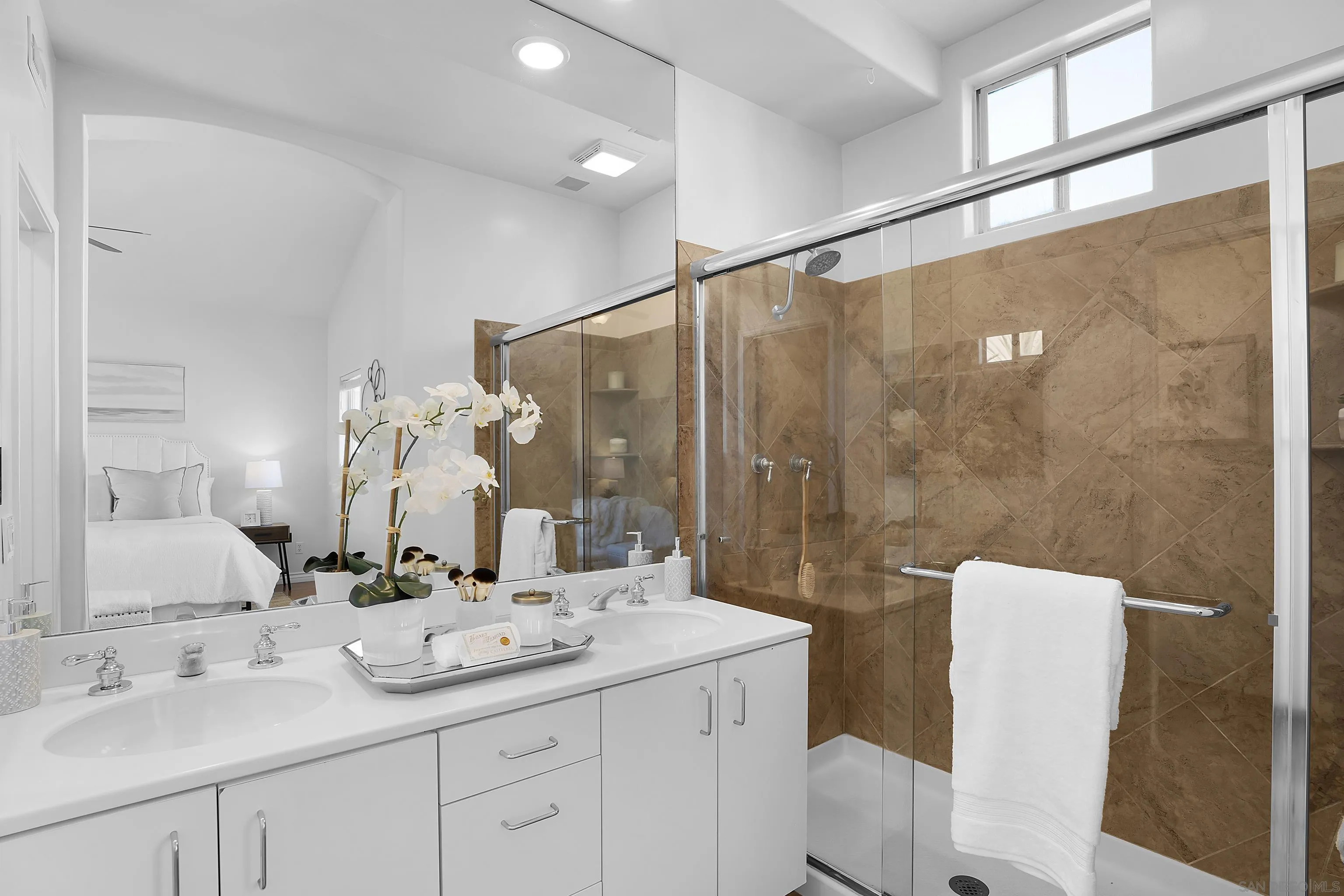 12646 Carmel Country Road, Unit 159 San Diego, CA 92130 - Photo 22 of 35 a bathroom with a double vanity sink and mirror