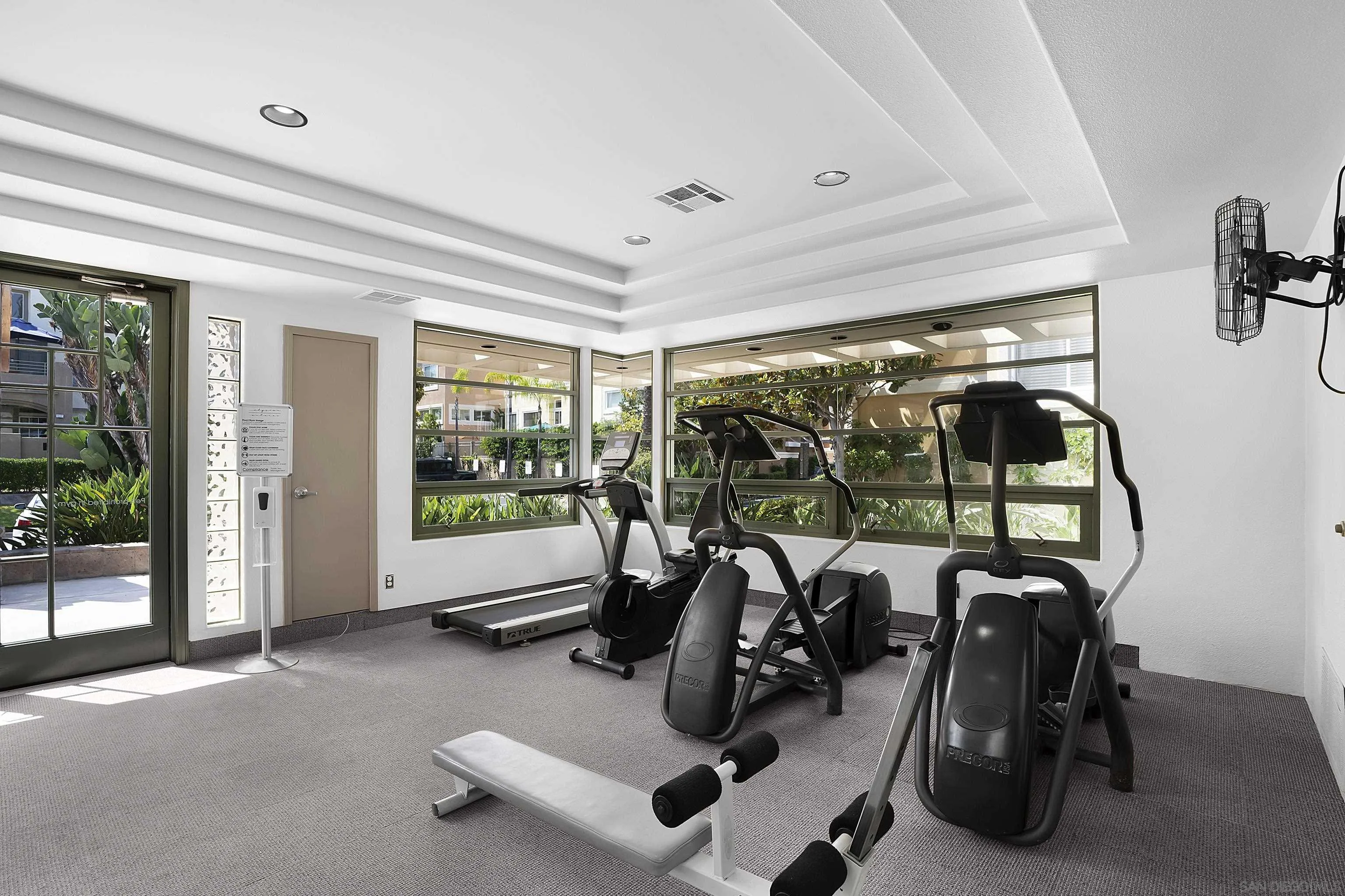 12646 Carmel Country Road, Unit 159 San Diego, CA 92130 - Photo 25 of 35 a room with gym equipment and large mirror