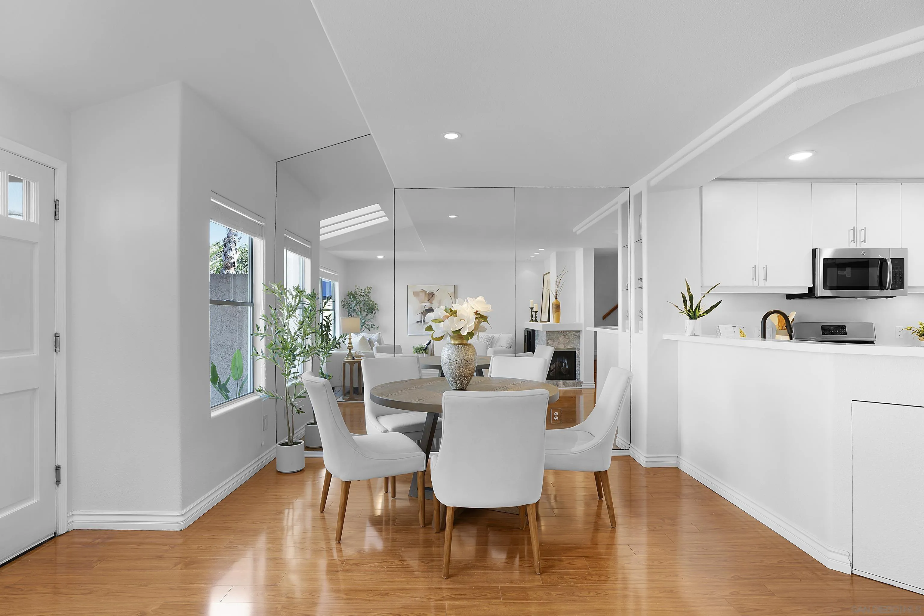 12646 Carmel Country Road, Unit 159 San Diego, CA 92130 - Photo 6 of 35 a view of a dining room with furniture a potted plant and wooden floor